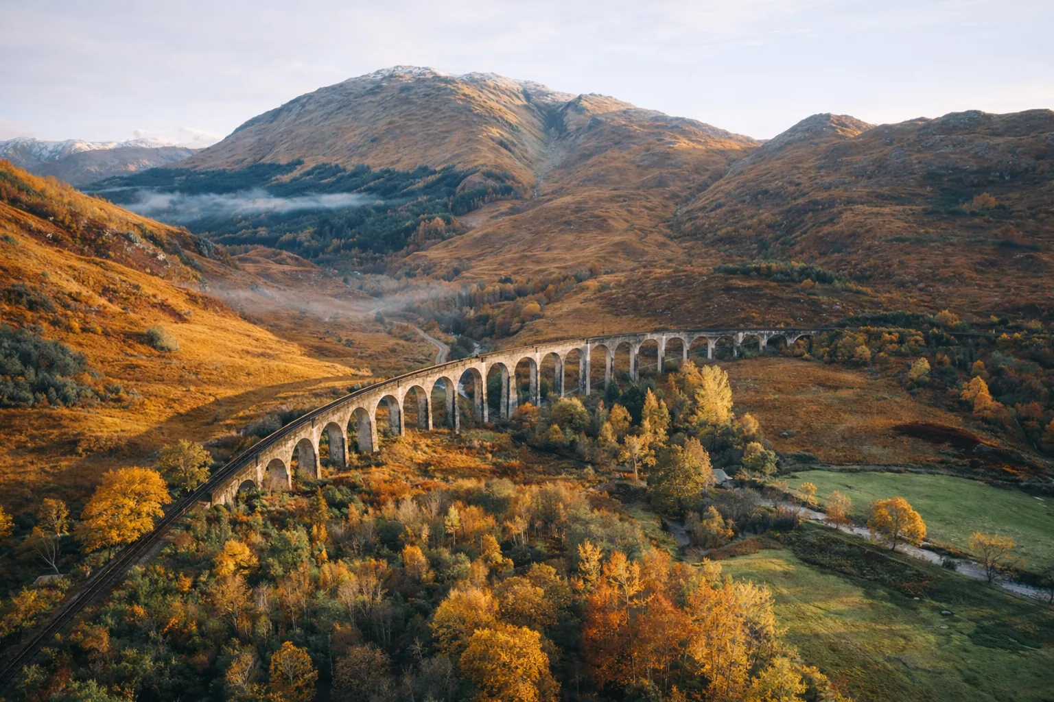 Autumn foliage in the Scottish Highlands with gold and amber hues against grey rock